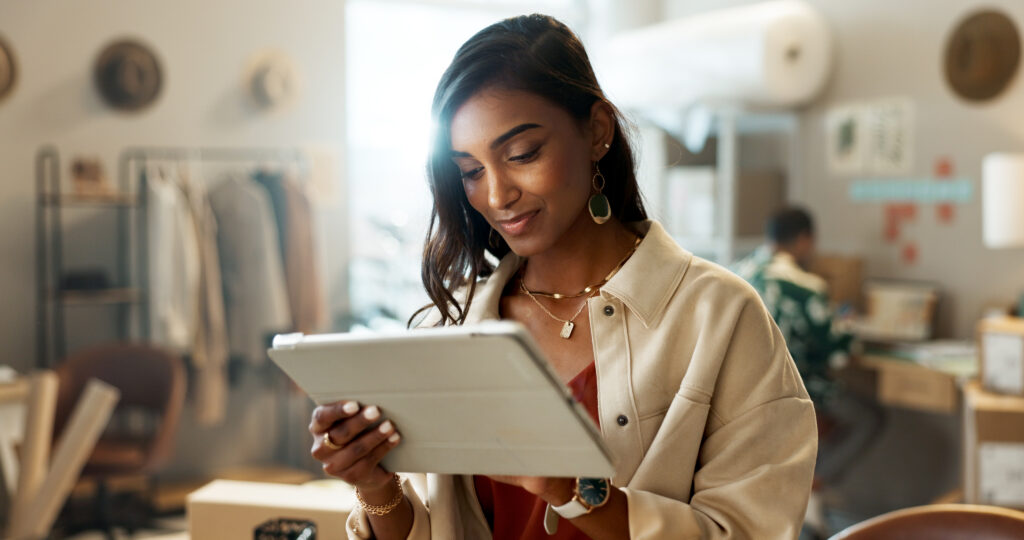 A confident young woman reviewing sponsored job opportunities, symbolizing career growth and job search for international job seekers in the UK